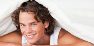 Man smiling in bed