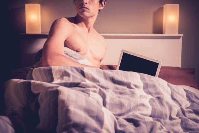 Man in bed with a computer