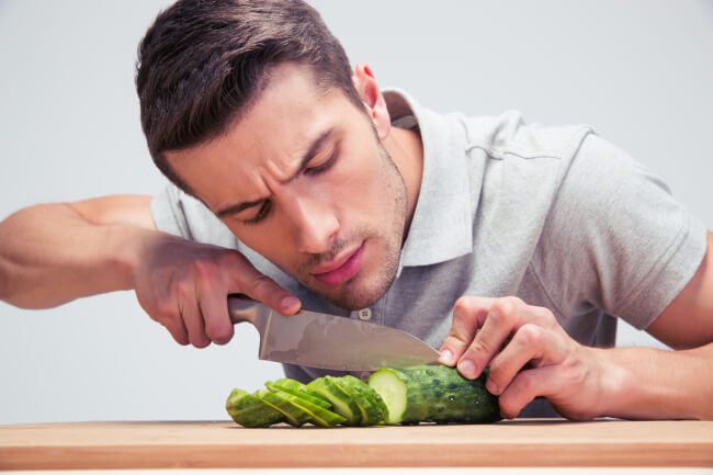 Man cutting cucumber