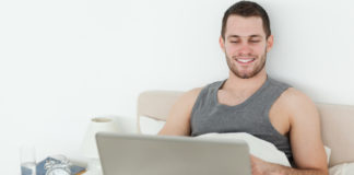 Man in bed with a laptop