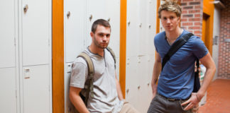 Students with bags in locker room