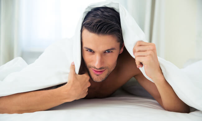 Man in bed under a blanket