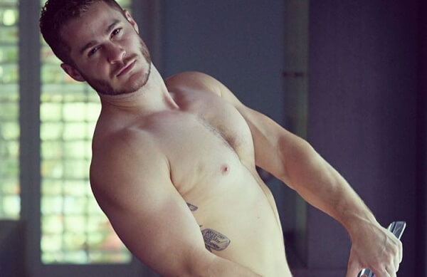 Austin Armacost naked on a chair