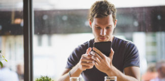 man with tablet in coffee shop