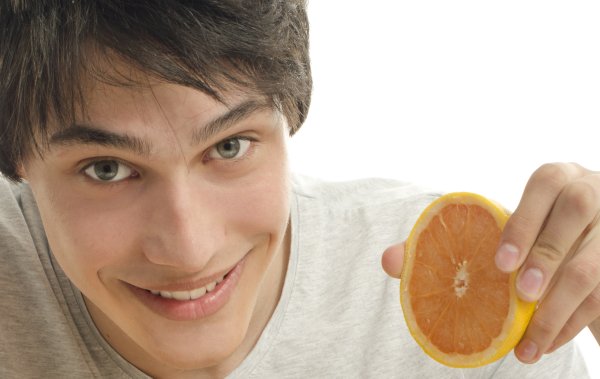 Man holding an orange