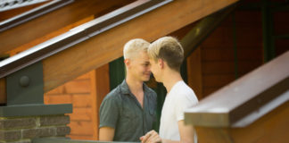 Two young men holding hands gay couple